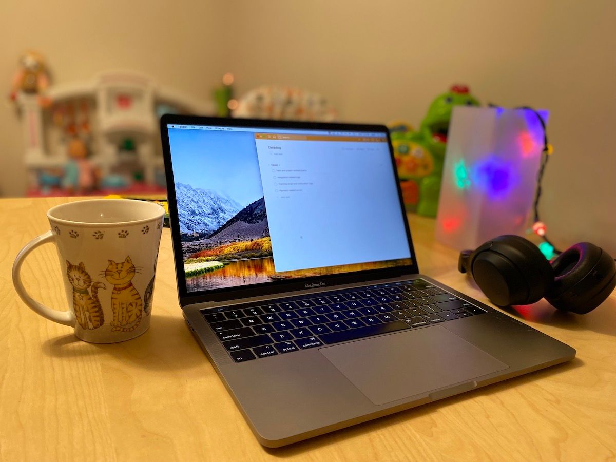 A laptop, a mug, and a pair of headphones.